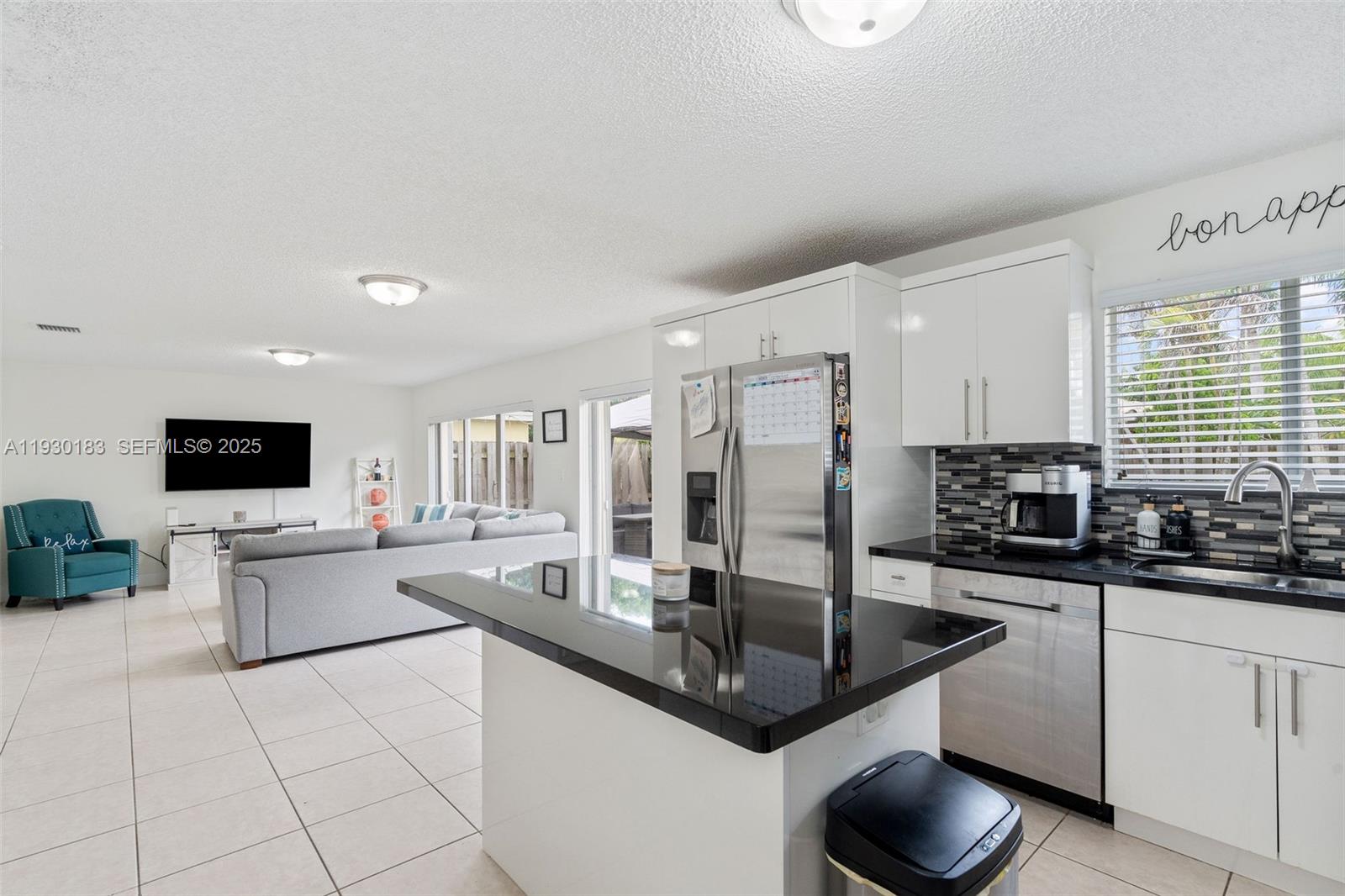 14152 Southwest 154th Court Miami, FL 33196 - Photo 11 of 33 a kitchen with stainless steel appliances granite countertop a sink a stove counter space and cabinets