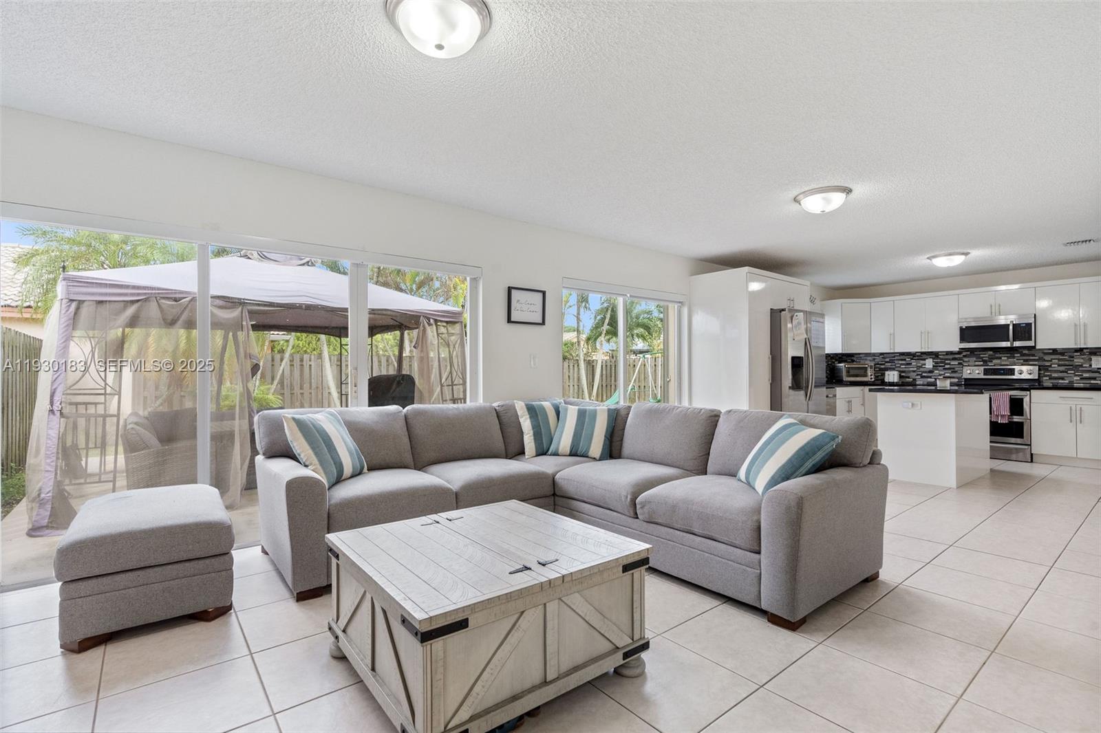 14152 Southwest 154th Court Miami, FL 33196 - Photo 13 of 33 a living room with furniture and a large window