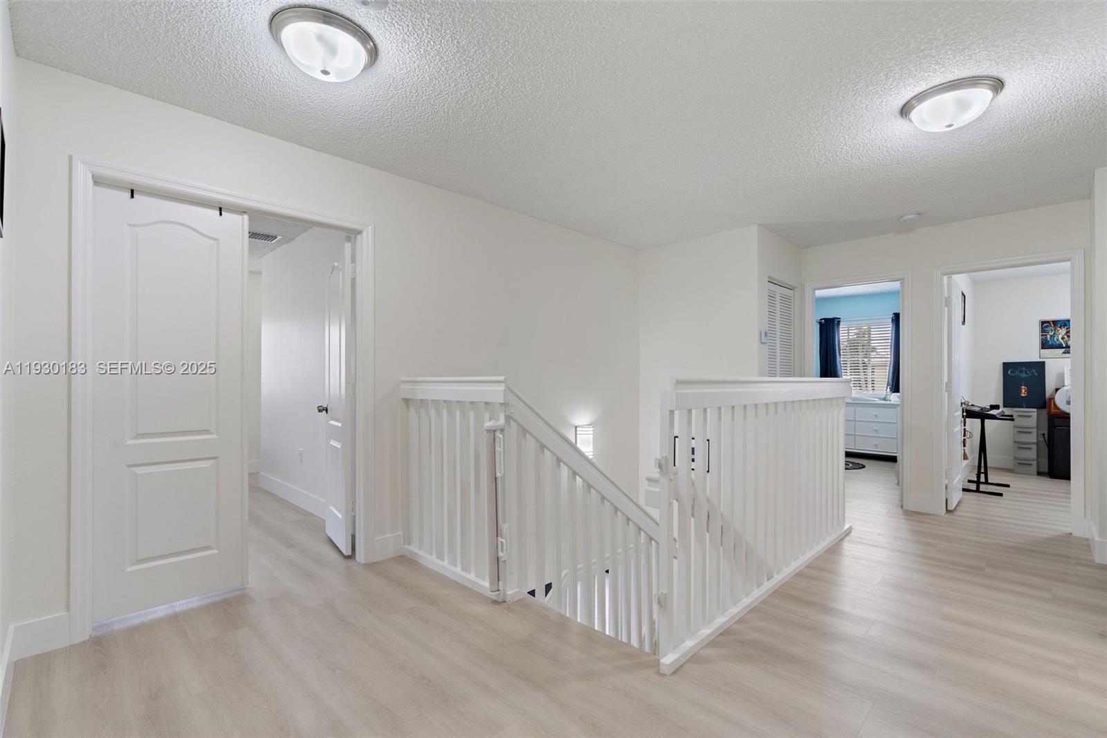 14152 Southwest 154th Court Miami, FL 33196 - Photo 29 of 33 a view of a hallway with closet and wooden floor