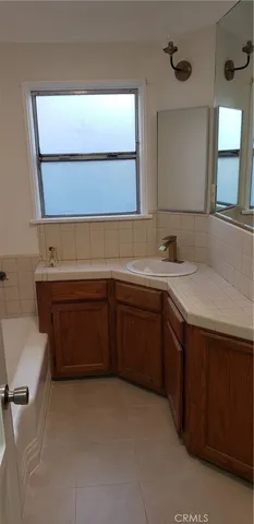 a view of a house with backyard and wooden fence
