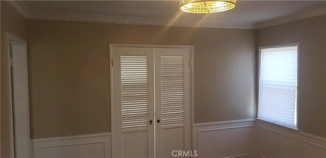 a view of empty room with window and wooden floor