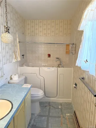 a bathroom with a sink a toilet and shower curtain