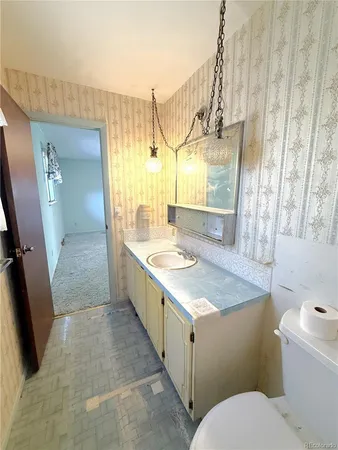 a bathroom with a granite countertop sink a mirror and a bathtub