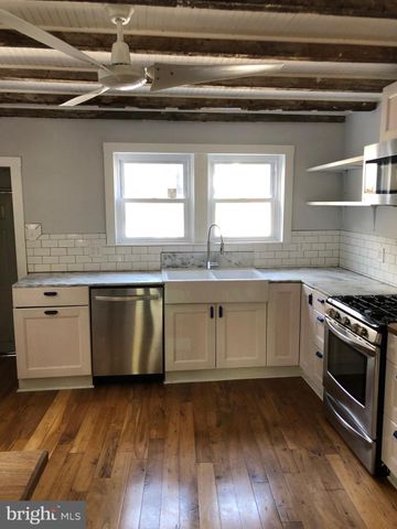 a white kitchen with a sink and a stove