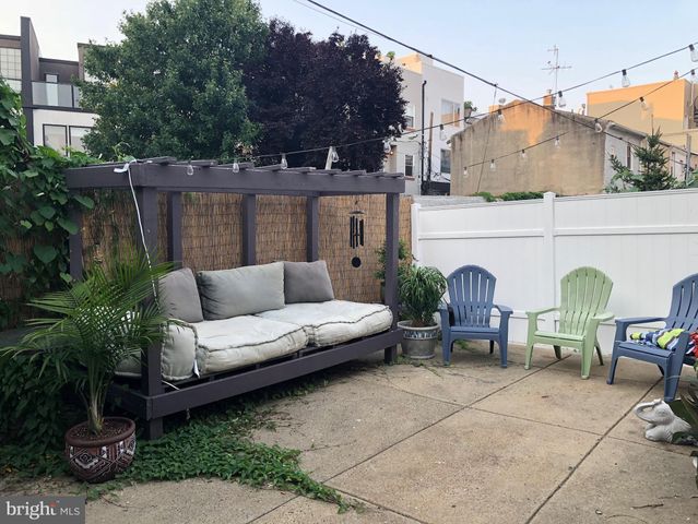 a view of a patio with couches and potted plants