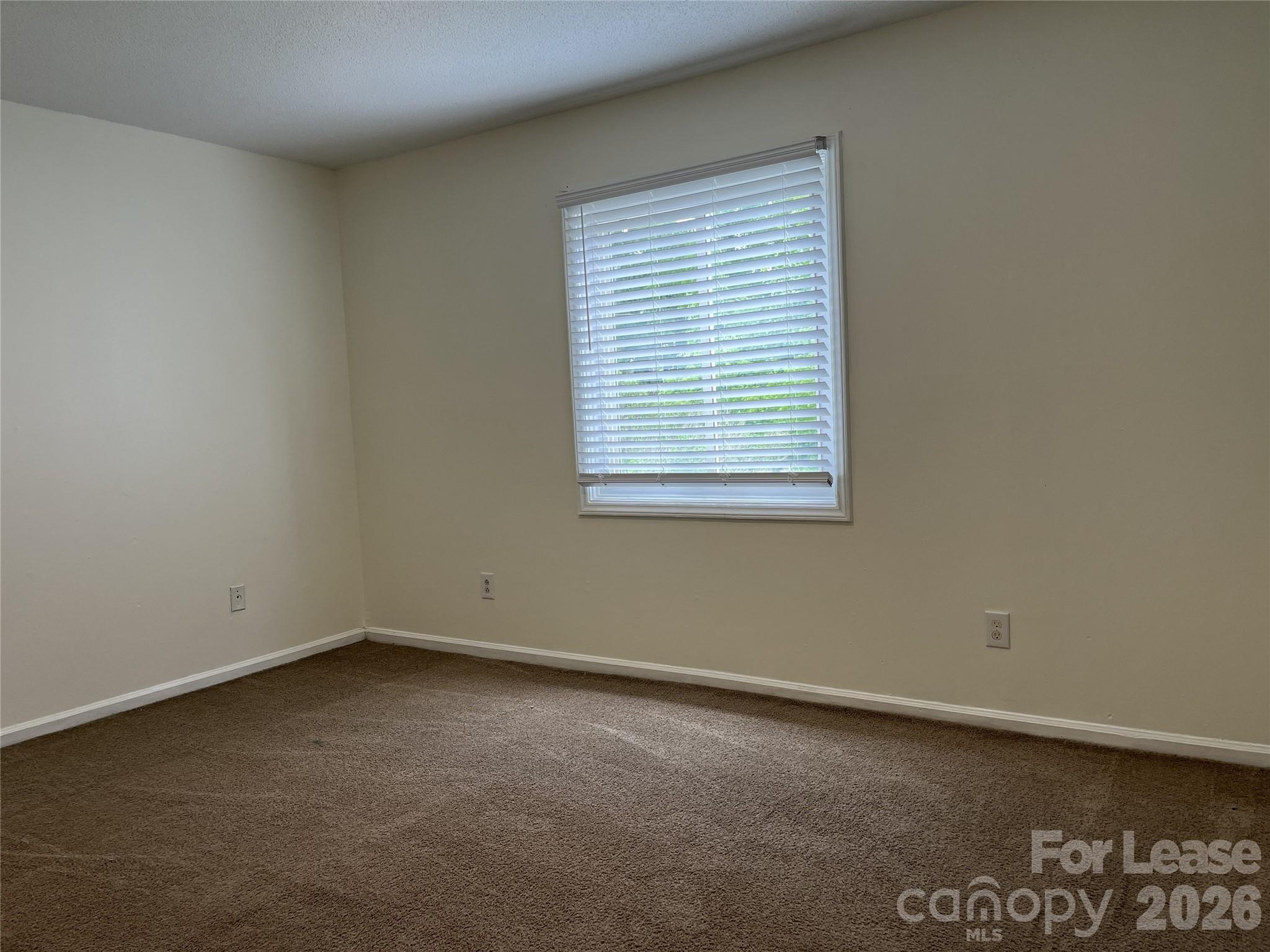 1911 Smoke Ridge Court, Unit 5 Charlotte, NC 28210 - Photo 11 of 16 an empty room with a window