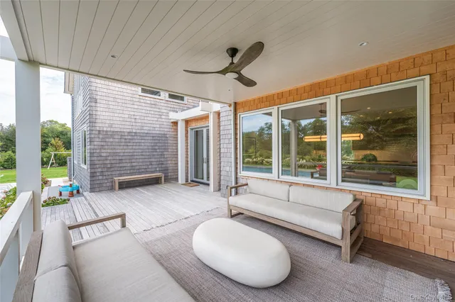 a living room with fireplace furniture and a large window