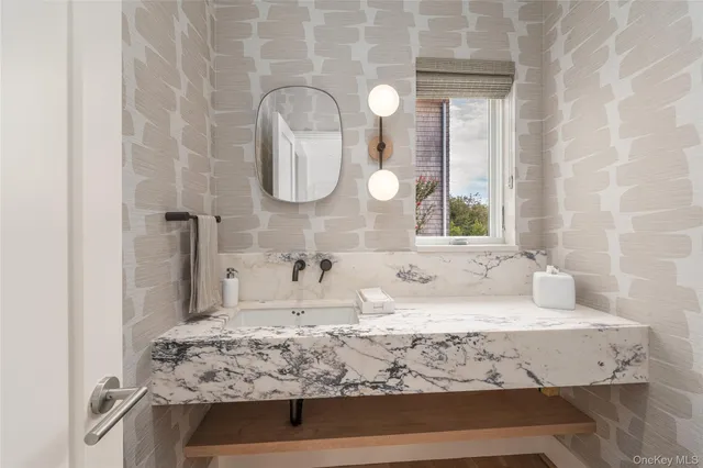 a kitchen with a dining table chairs and wooden floor
