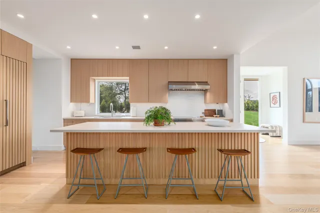 a kitchen with stainless steel appliances granite countertop a sink and a refrigerator