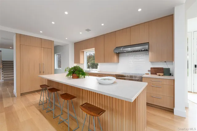a kitchen with granite countertop a sink and stove top oven