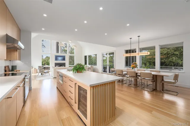 a kitchen with kitchen island a dining table and chairs