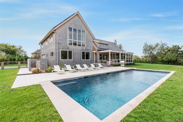 a front view of a house with swimming pool yard and outdoor seating