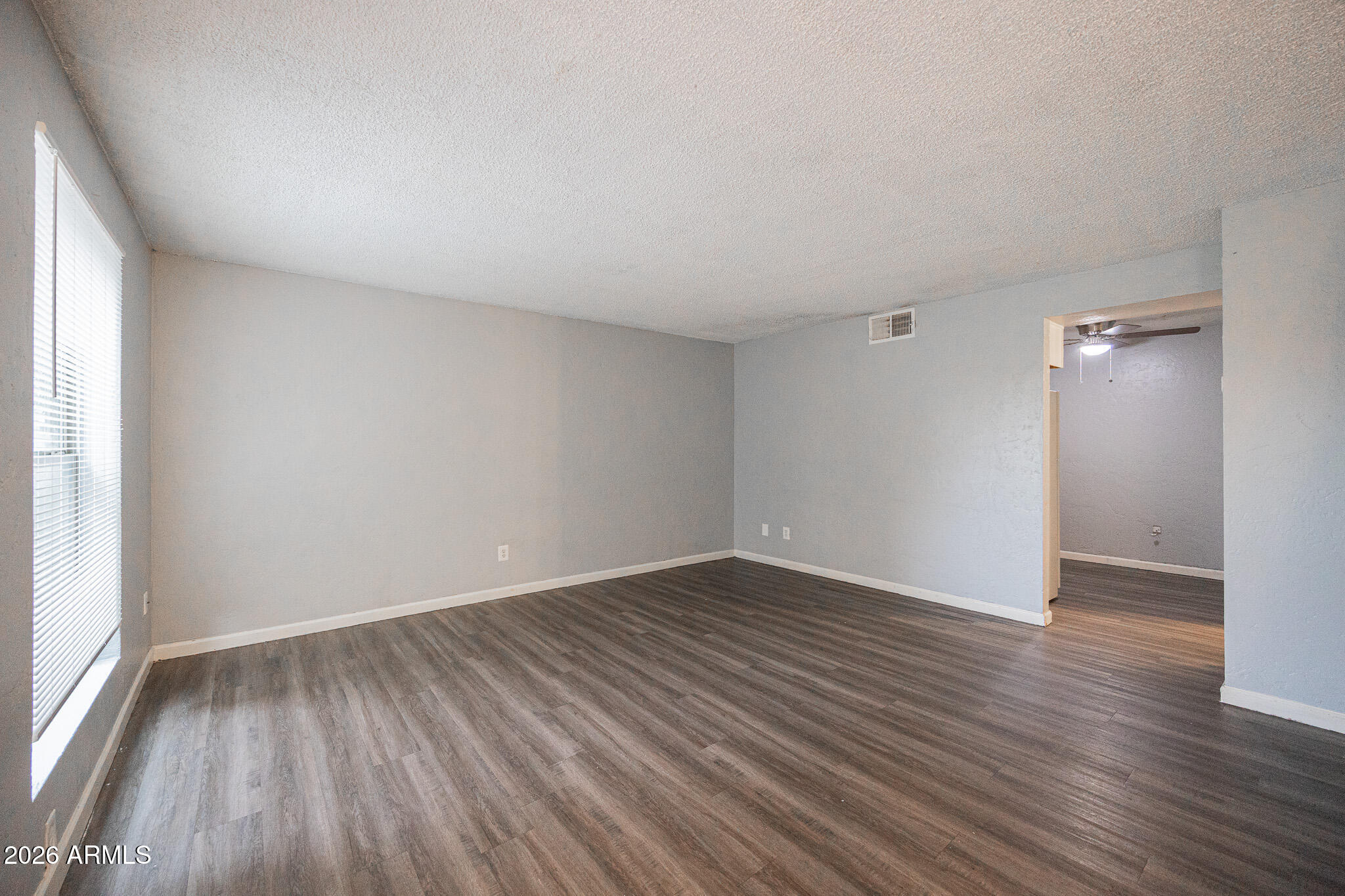 4615 North 39th Avenue, Unit 24 Phoenix, AZ 85019 - Photo 3 of 17 a view of an empty room with wooden floor