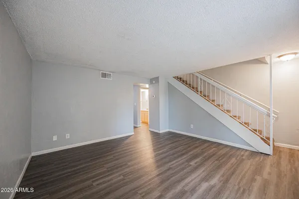 a view of an empty room with wooden floor