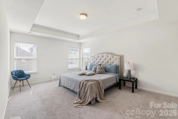 a living room with furniture a flat screen tv and a window