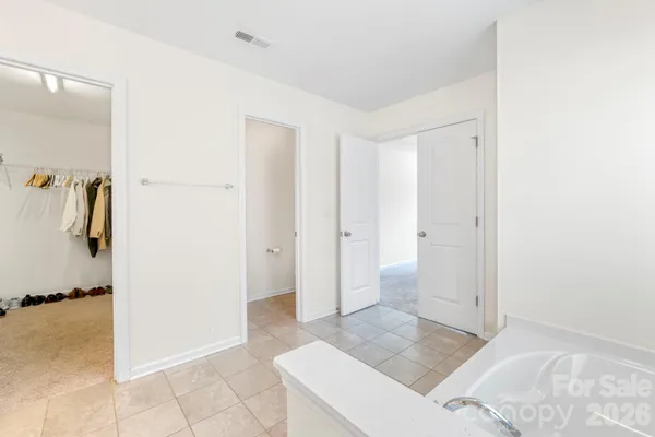 a spacious bathroom with a tub sink shower and mirror