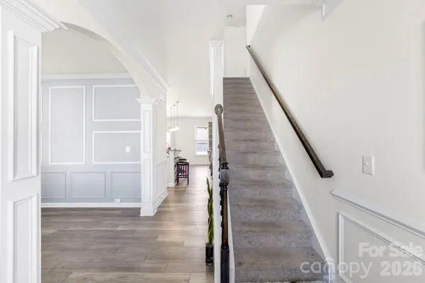 a view of entryway and hall with wooden floor