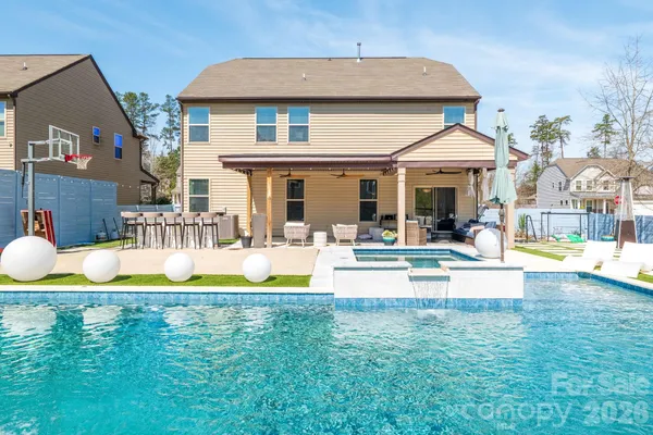 a view of a house with swimming pool yard and porch