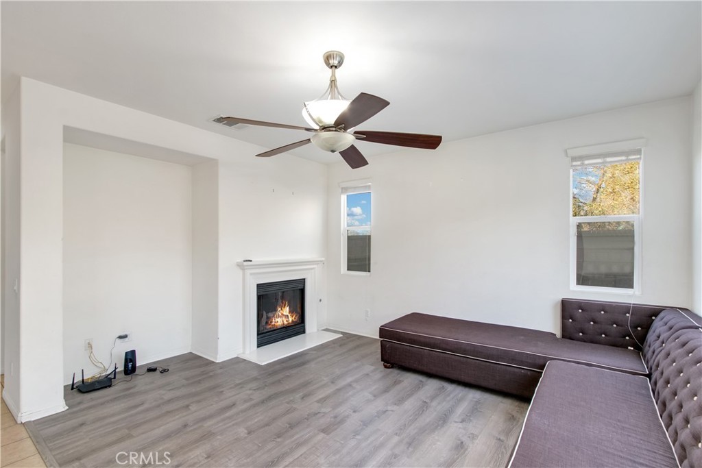 34020 Crenshaw Street Beaumont, CA 92223 - Photo 11 of 36 a living room with furniture and a fireplace