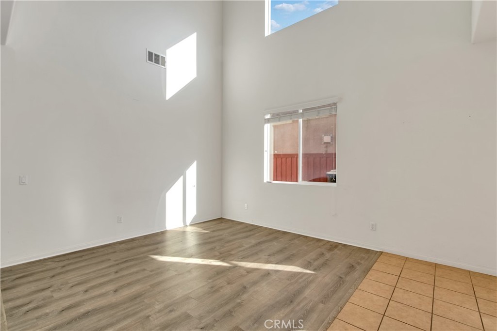 34020 Crenshaw Street Beaumont, CA 92223 - Photo 14 of 36 an empty room with wooden floor and windows