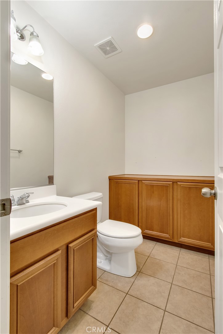 34020 Crenshaw Street Beaumont, CA 92223 - Photo 15 of 36 a bathroom with a sink a toilet and mirror