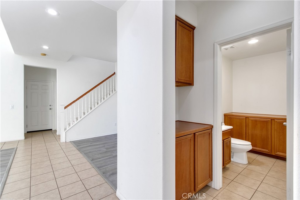 34020 Crenshaw Street Beaumont, CA 92223 - Photo 16 of 36 a view of a hallway with wooden floor and furniture