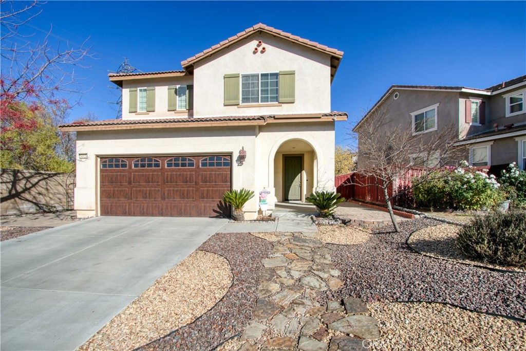 34020 Crenshaw Street Beaumont, CA 92223 - Photo 2 of 36 a front view of a house with a yard and garage