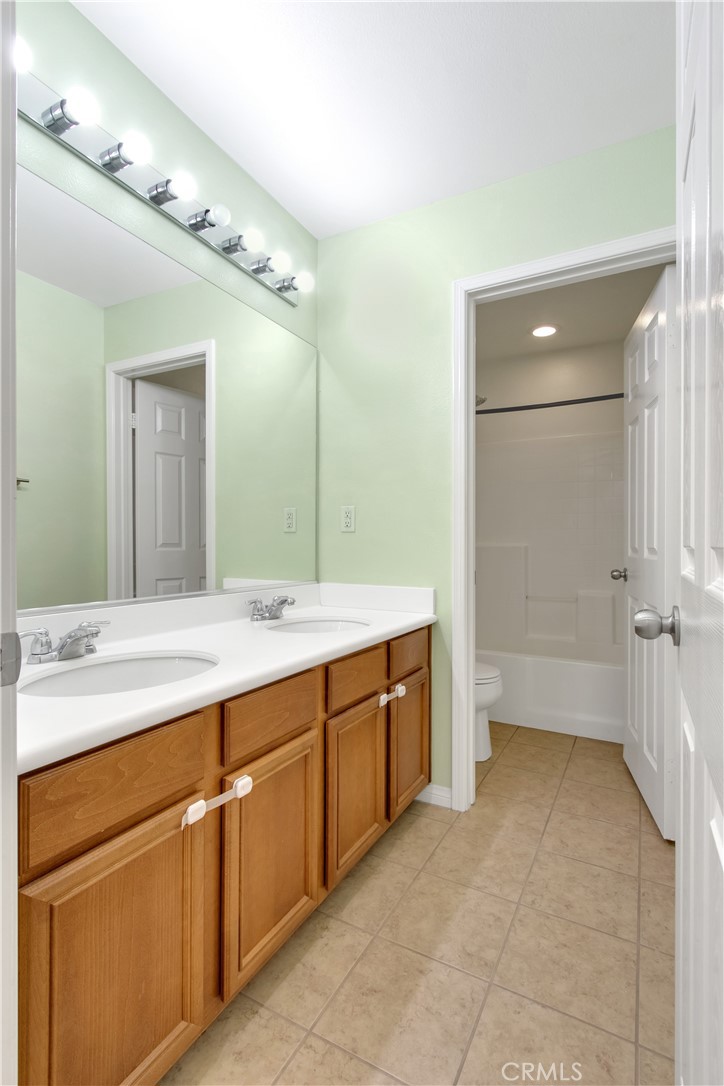 34020 Crenshaw Street Beaumont, CA 92223 - Photo 26 of 36 a spacious bathroom with a granite countertop sink mirror and a