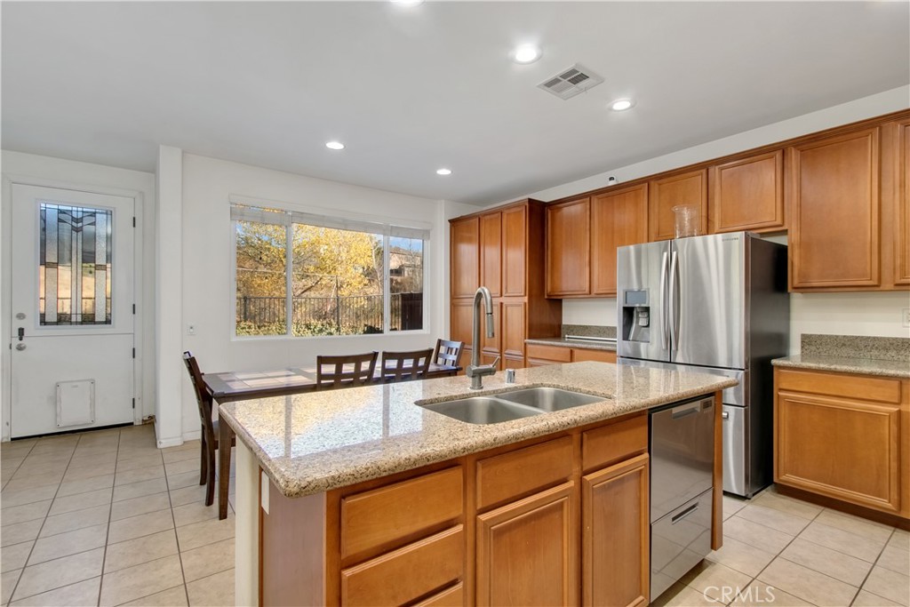 34020 Crenshaw Street Beaumont, CA 92223 - Photo 4 of 36 a kitchen with a refrigerator a sink and cabinets