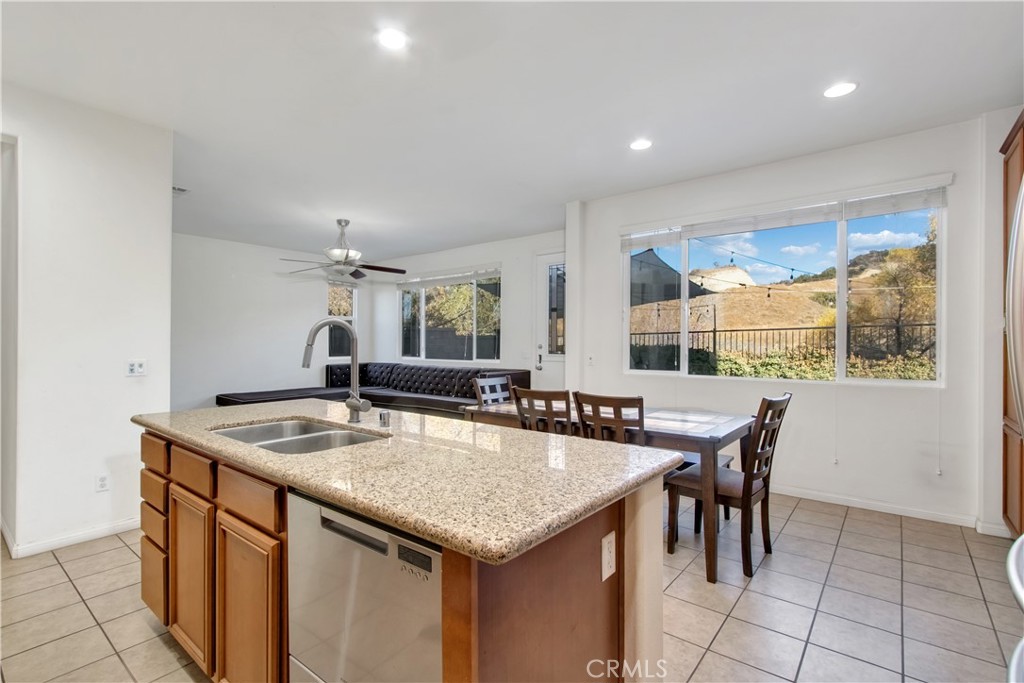 34020 Crenshaw Street Beaumont, CA 92223 - Photo 5 of 36 a kitchen with granite countertop a table and chairs