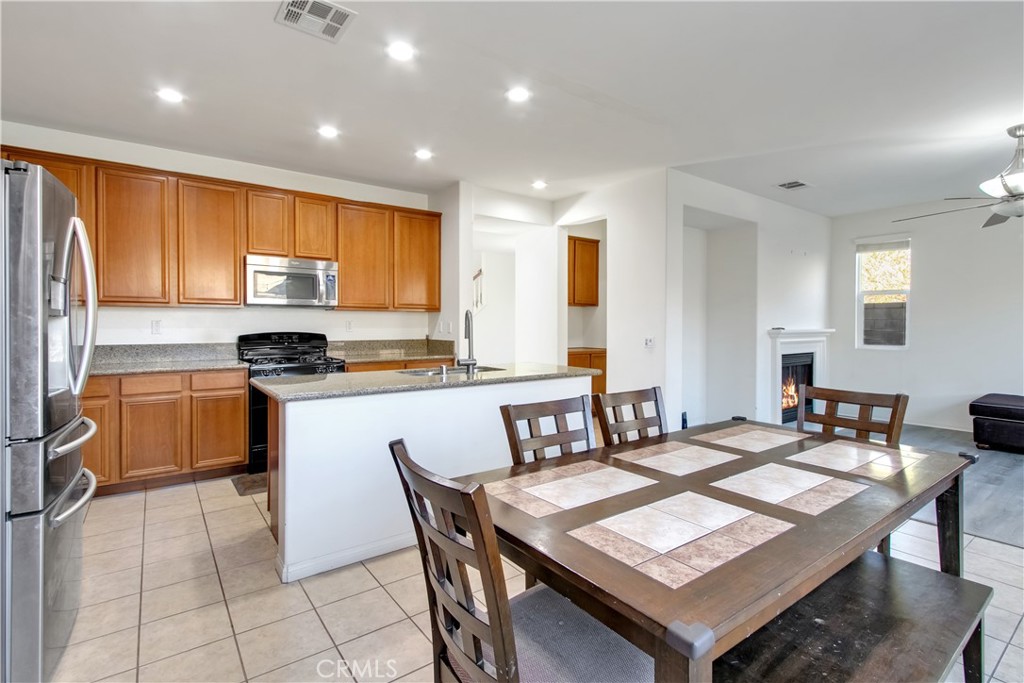 34020 Crenshaw Street Beaumont, CA 92223 - Photo 6 of 36 a kitchen with a dining table chairs and refrigerator
