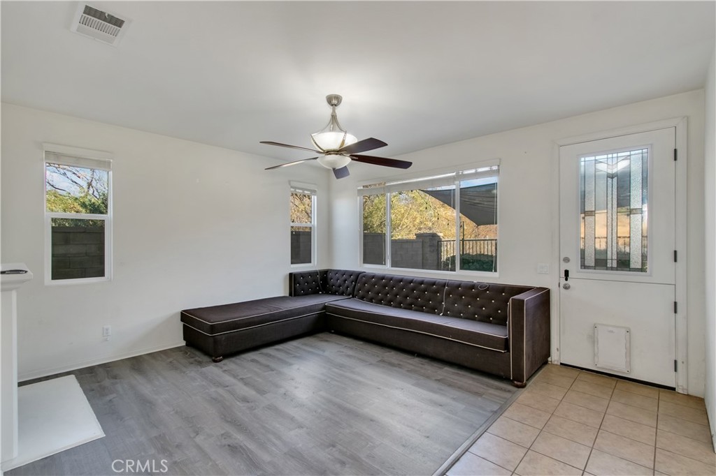 34020 Crenshaw Street Beaumont, CA 92223 - Photo 8 of 36 a living room with furniture and a chandelier