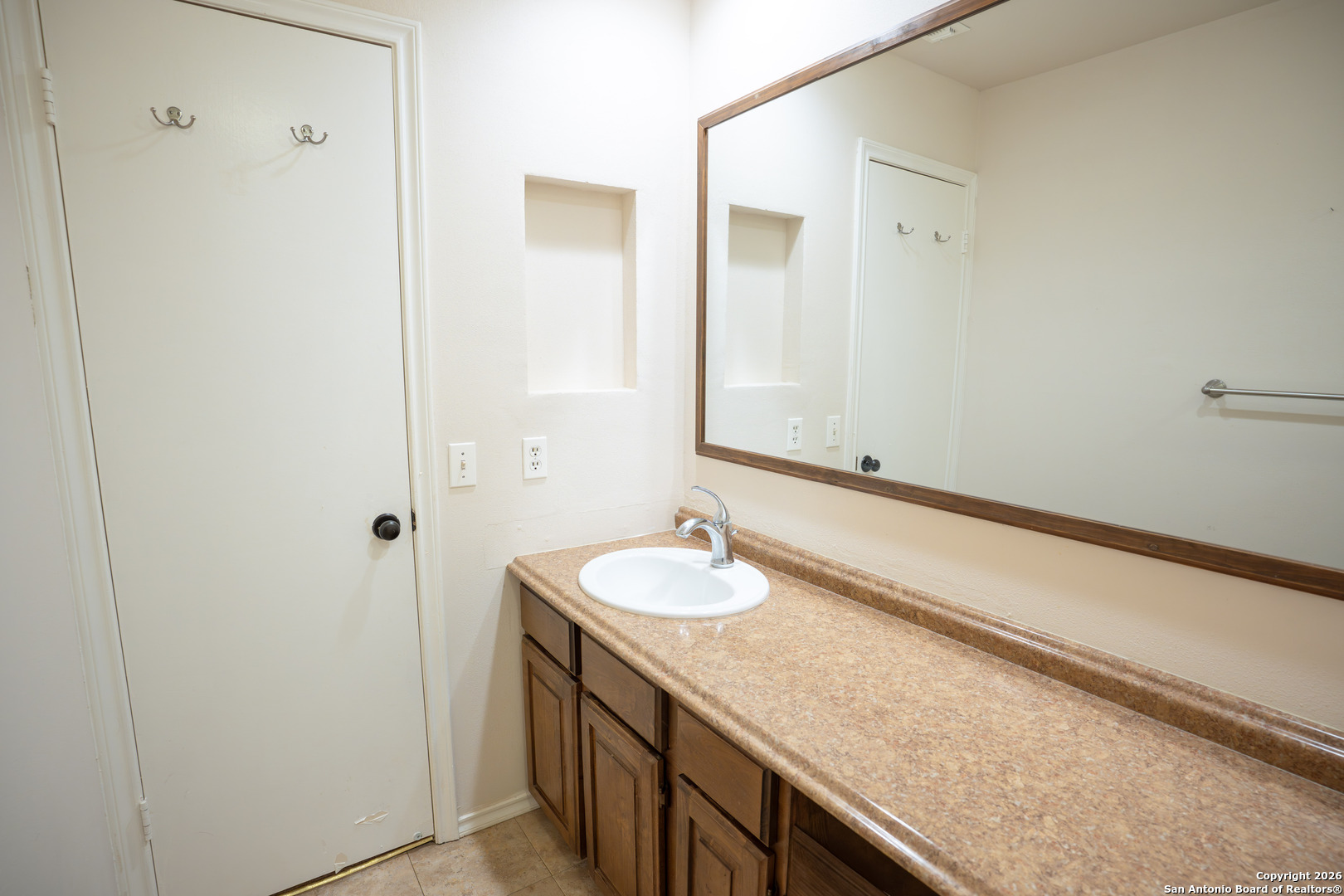 11001 Wurzbach Road, Unit 401 San Antonio, TX 78230 - Photo 11 of 12 a bathroom with a granite countertop sink and a mirror