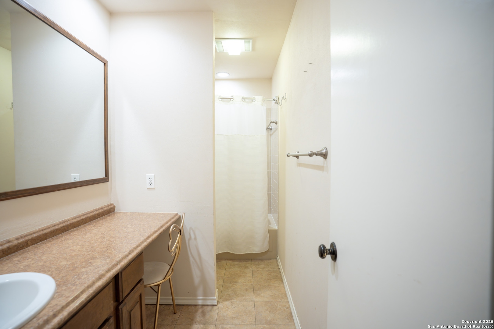 11001 Wurzbach Road, Unit 401 San Antonio, TX 78230 - Photo 6 of 12 a bathroom with a granite countertop sink and a mirror