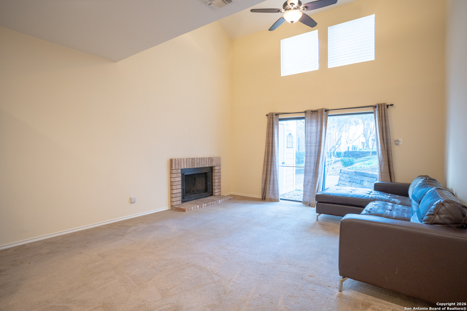 11001 Wurzbach Road, Unit 401 San Antonio, TX 78230 - Photo 7 of 12 a living room with furniture and a fireplace