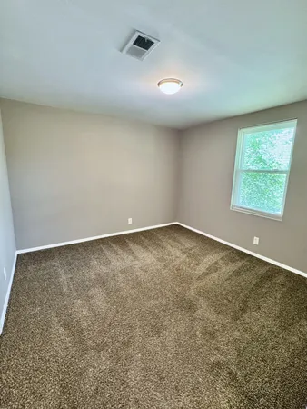 an empty room with a empty space and a window