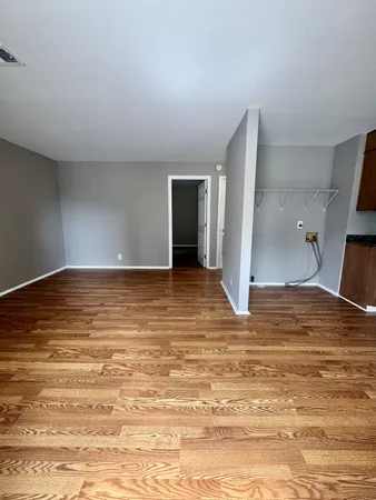 a view of a room with wooden floor
