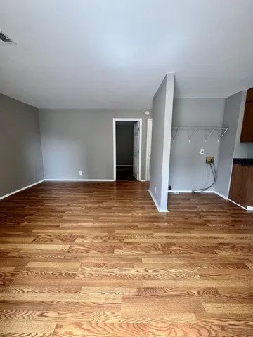 a view of a room with wooden floor
