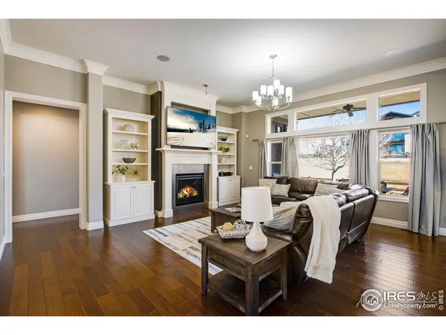 a living room with furniture wooden floor and a chandelier