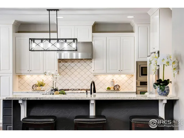 a kitchen with stainless steel appliances a sink stove and refrigerator