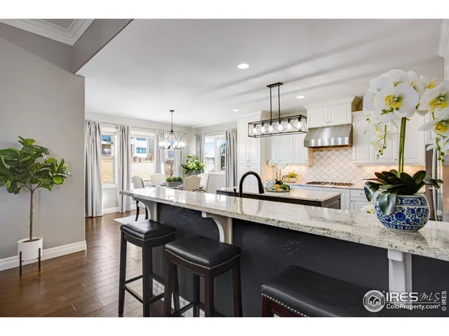 a kitchen with a sink a stove and cabinets