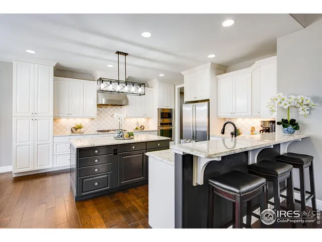 a kitchen with sink and refrigerator