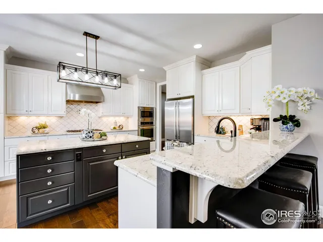 a kitchen with sink and refrigerator