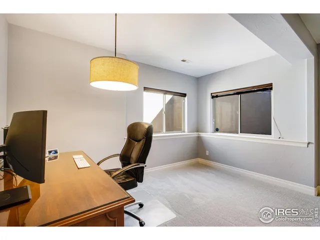 a bedroom with a bed and painting on the wall