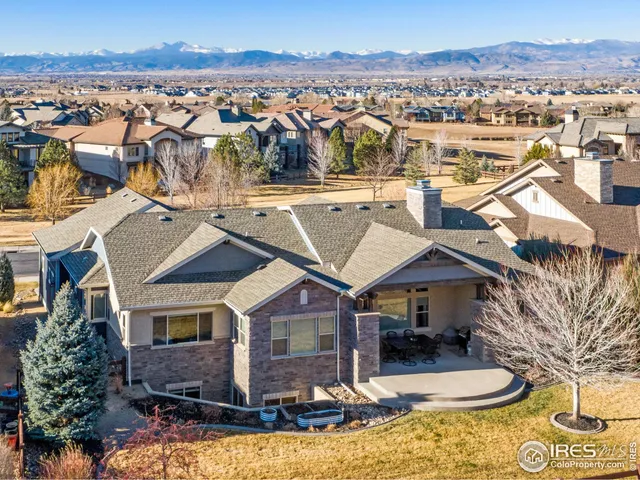 an aerial view of a house with a yard lake view and mountain view
