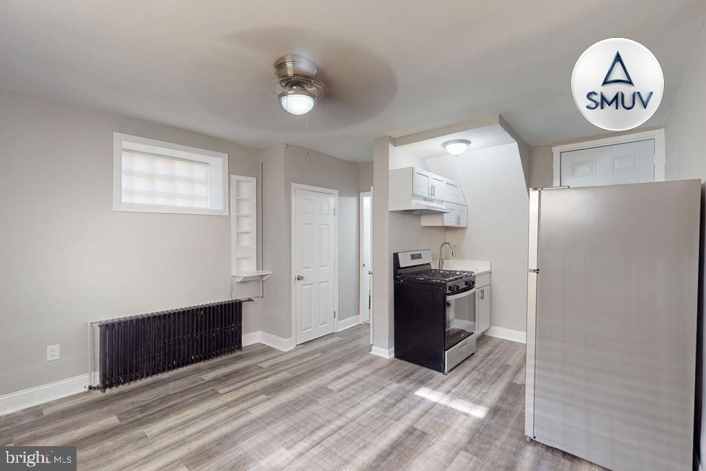 1605 Homestead Street, Unit 12 Baltimore, MD 21218 - Photo 1 of 12 a view of a kitchen with fridge and wooden floor