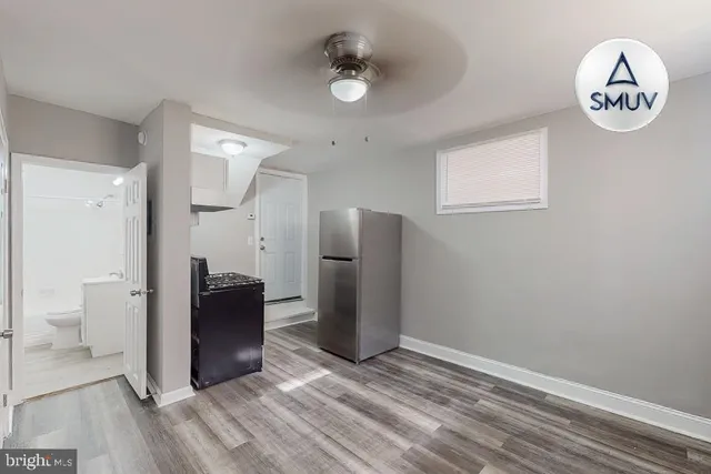 a view of kitchen with refrigerator and window