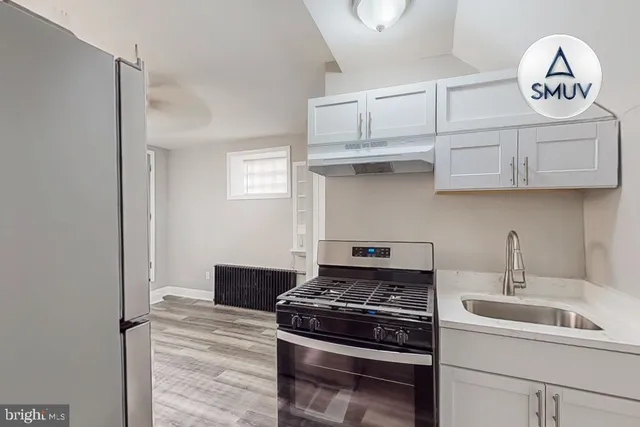 a kitchen with stainless steel appliances granite countertop a stove and a sink