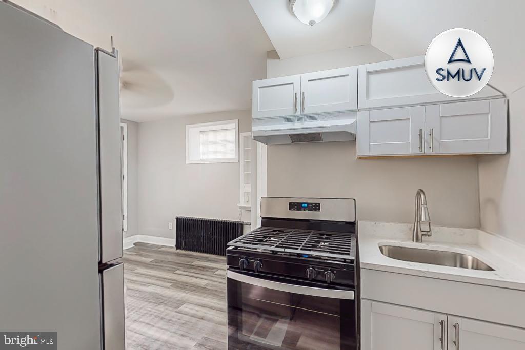 1605 Homestead Street, Unit 12 Baltimore, MD 21218 - Photo 3 of 12 a kitchen with stainless steel appliances granite countertop a stove and a sink