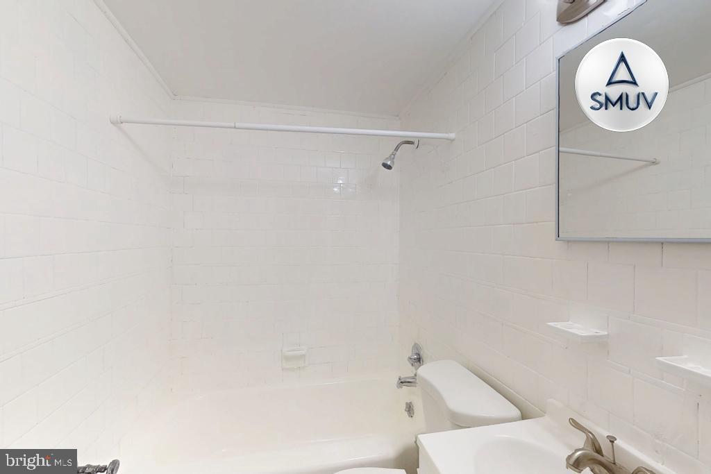 1605 Homestead Street, Unit 12 Baltimore, MD 21218 - Photo 5 of 12 a bathroom with a toilet and a shower